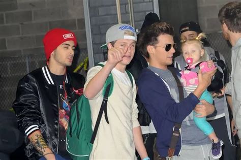 Louis Tomlinson Cradles A Baby As One Direction Greet Their Families In