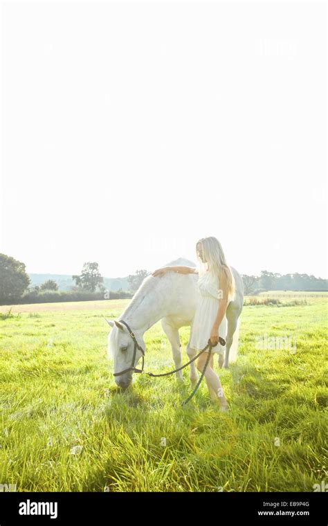 Young Woman Stroking Horse In Hi Res Stock Photography And Images Alamy