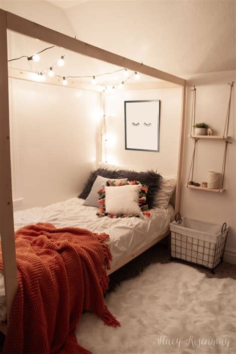 A Bedroom With White Walls And Lights Strung From The Ceiling Bed