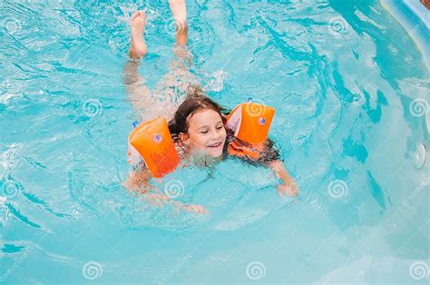 Little Girls Is Swimming In The Pool By A Summer Day Stock Image