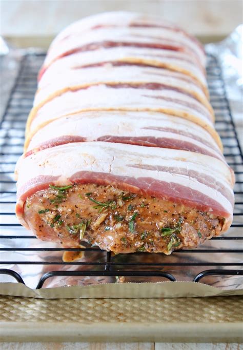 It is company pleasing and holiday in this recipe, the pork is rubbed with seasonings, seared until golden, then showered with herbs, lemon juice and butter, then baked enclosed in foil while the. Bacon Wrapped Balsamic Pork Loin Recipe - WhitneyBond.com