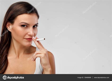 Beautiful Woman Smoking Cigarettes On White Background Stock Photo By