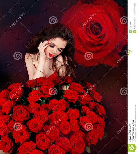 Young Beautiful Woman With Red Roses Bouquet Over Flowers