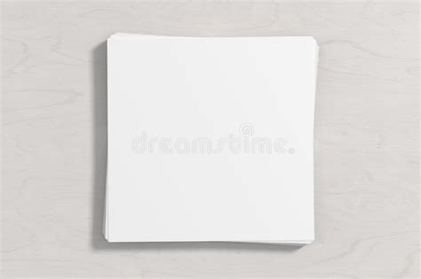 Stack Of Square Sheets Of Paper On The White Wooden Table Stock
