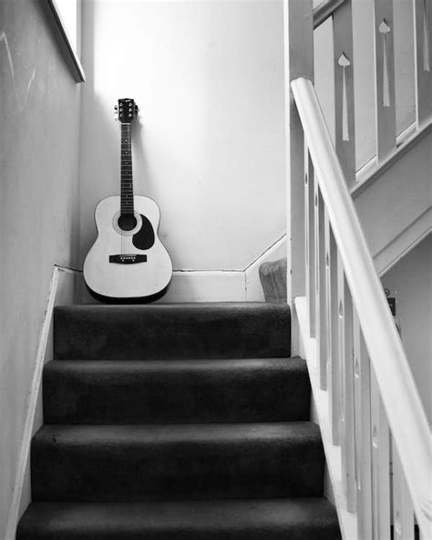 Grayscale Photo Of Acoustic Guitar On Staircase · Free Stock Photo