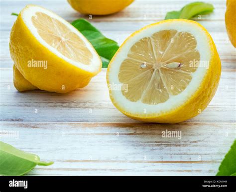 Closeup Fresh Lemons And Lemons Leaves On Shabby Wooden Background