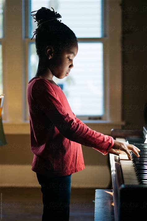 African American Girl Playing Piano By Stocksy Contributor Gabi