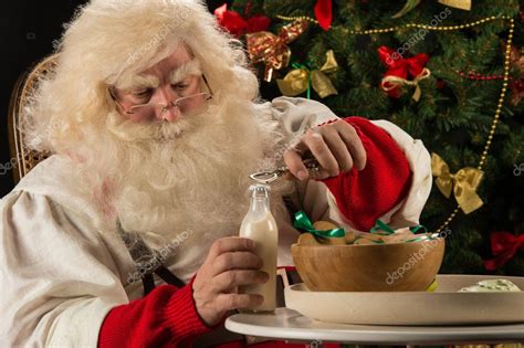 Santa Claus Eating Cookies — Stock Photo © Hasloo 33882363