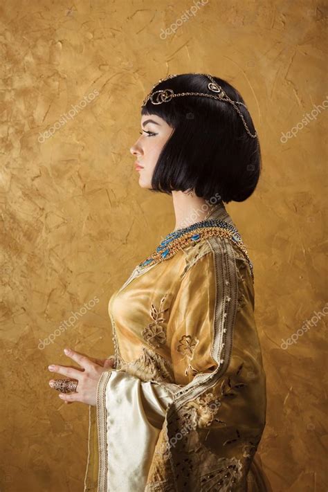 Beautiful Woman Like Egyptian Queen Cleopatra On Golden Background Side View Face Profile