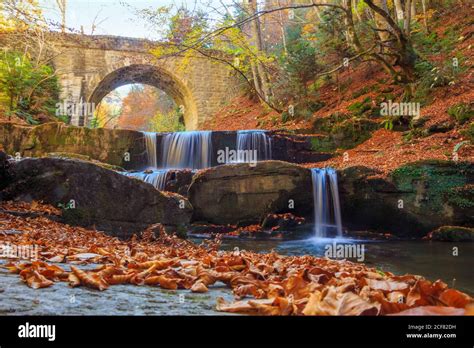Autumn Waterfall Under Stone Bridge In The Mountain Stock Photo Alamy