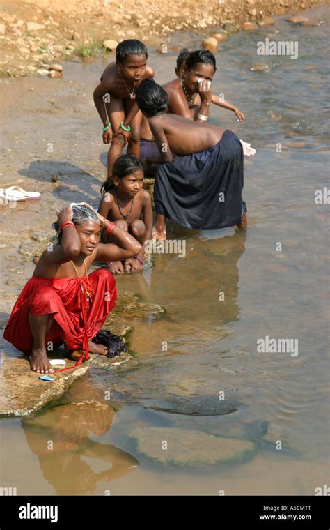 Tribal Group Bathing In Local River Bhatpur Orissa India Stock Photo