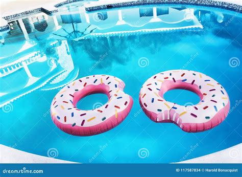 Two Pink Float Rings In A Swimming Pool Stock Photo Image Of Plastic