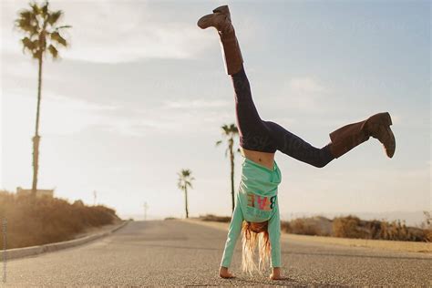 Young Girl Doing A Cartwheel By Stocksy Contributor Sidney