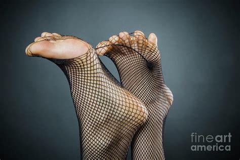 Womans Feet Poking Through Fishnet Photograph By Sven Hagolani Fine