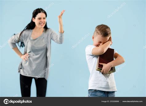 Angry Mother Scolding Her Son In Living Room At Home Stock Photo By