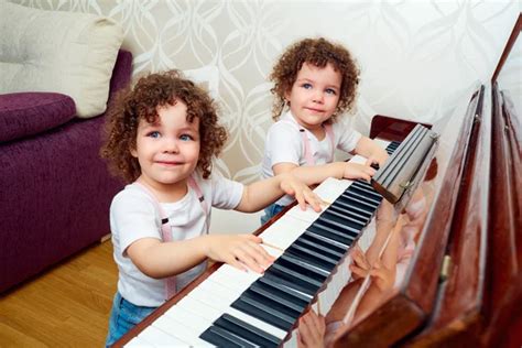 Two Funny Twin Playing The Piano Together Smiling Laughing Ch