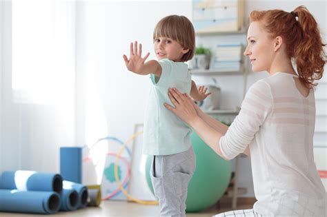 Get help & get happy! Child During Physical Therapy Session Stock Photo ...