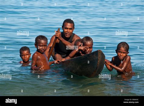 A Man And Children With A Canoe Savo Island Central Province Solomon