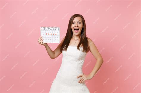 Premium Photo Surprised Woman In White Dress Holding Female Periods