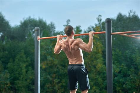 Strong Shirtless Man Doing Pull Ups On Horizontal Bar Stock Image