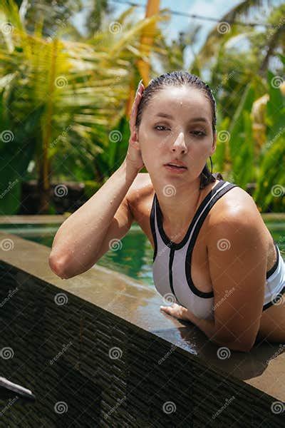With A Languor Opening Her Lips The Girl Strokes Her Wet Hair Coming Out Of The Pool Against The
