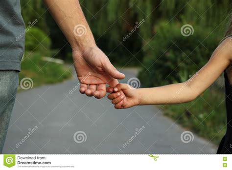 Parent Holds The Hand Of A Small Child Stock Image Image Of Green