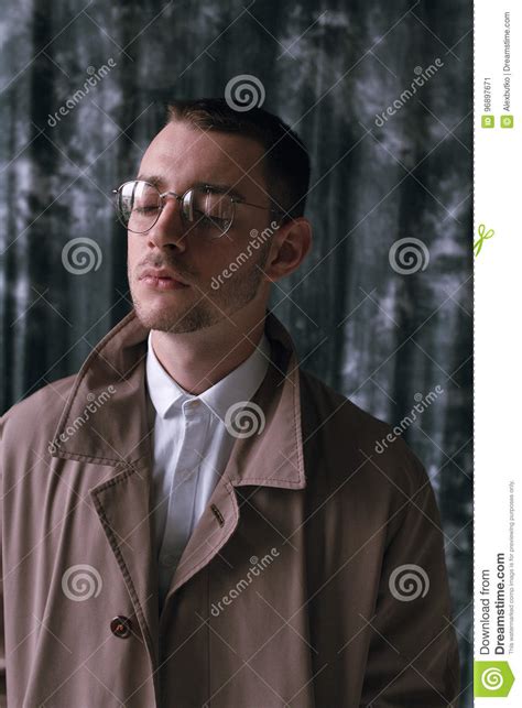 A Lonely Handsome Guy In A Raincoat And Glasses With Different Moods