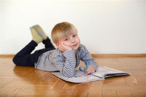 Premium Photo Cute Boy Reads The Book On The Floor At Home
