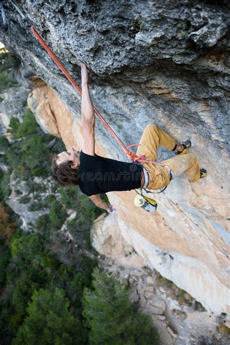 Outdoor Sport Activity Rock Climber Ascending A Challenging Cliff