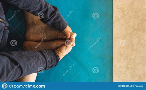 Overhead View Of Hands Holding Feet During A Stretch In Yoga Practice