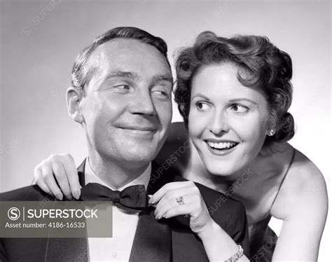 1950s Couple Dressed In Formal Attire Woman Pulling On Man S Bowtie Superstock