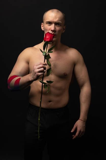 Premium Photo Athletic Man Holding A Red Rose Naked For The Day Of Velentin Pumped Up On His