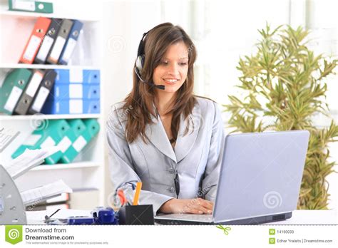 Beautiful Business Woman Working At Her Desk With Stock