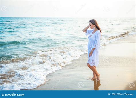 Young Woman Standing By Sea And Looking To Horizon Summer Holidays