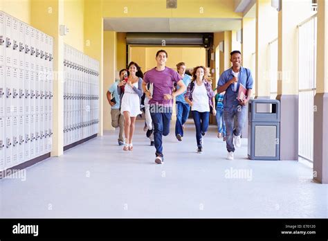 Group Of High School Students Running In Corridor Stock Photo Alamy