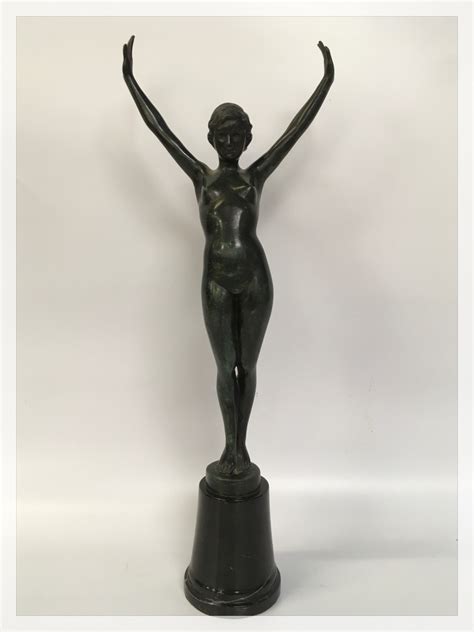 AN ART DECO PATINATED BRONZE OF A NUDE FEMALE DANCER MOUNTED ON BLACK