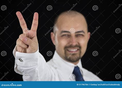 Smiling Business Man Making Peace Sign With His Fingers Stock Photo