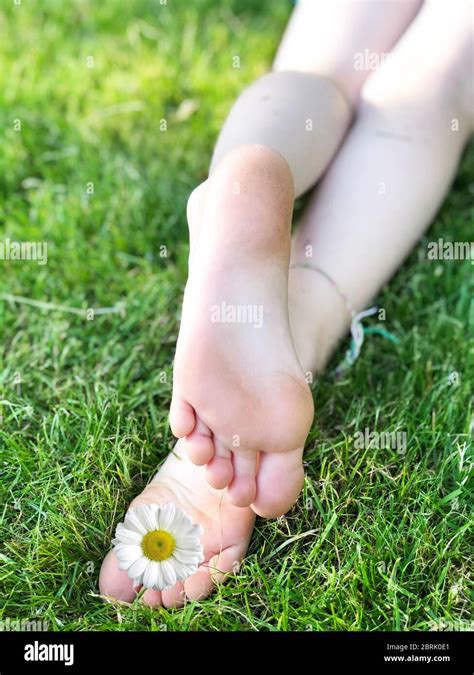 Child Feet On Green Grass In A Summer Park Stock Photo Alamy