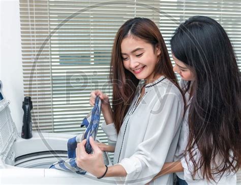 Image Of Asian Couple Women Doing Housework And Chores In Front Of