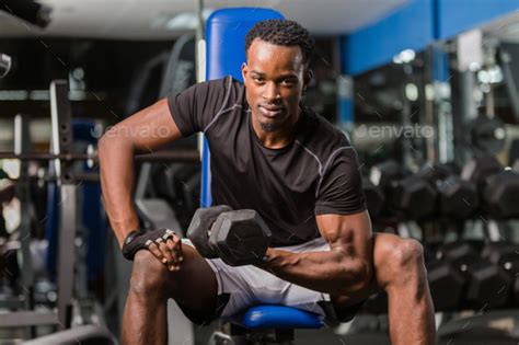 Black African American Young Man Doing Workout At The Gym Stock Photo