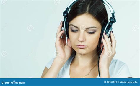 Attractive Dark Haired Girl Puts On Headphones And Listening To Music Stock Video Video Of
