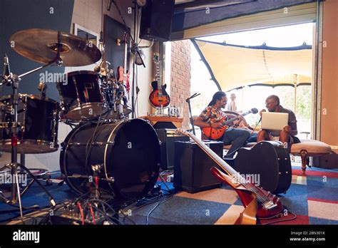 Male Musicians Practicing In Garage Recording Studio Stock Photo Alamy