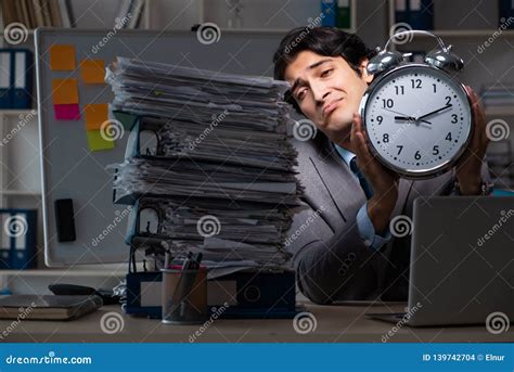 The Young Male Employee Working Late At Office Stock Photo Image Of
