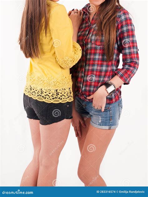 Enchanting Embrace: Mesmerizing Duo in Shorts Revel in Studio Elegance