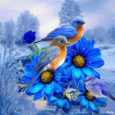 Two Birds Sitting On Top Of Blue Flowers
