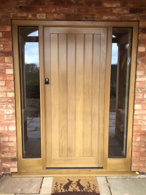 Pivot timber entry door and board and batten cladding at the village house by glow design group. Timber Entrance Doors | High Performance Windows