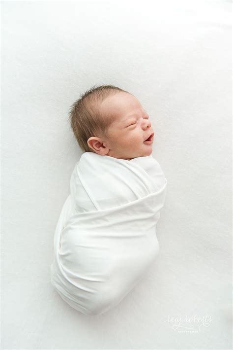 Simple And Clean Newborn Photography Baby Boy Swaddled In White