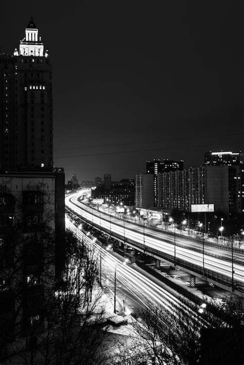 Grayscale Photo Of City Buildings During Nighttime · Free Stock Photo