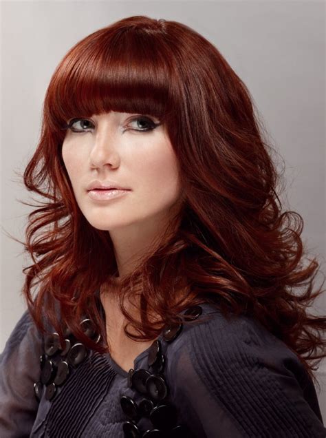 Create curtain bangs and slightly wave your hair. Long layered red hair with curls and a low above the eyes ...