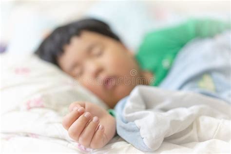 A Sleepy Child Is Sleeping On The Comfortable Bed Stock Image Image